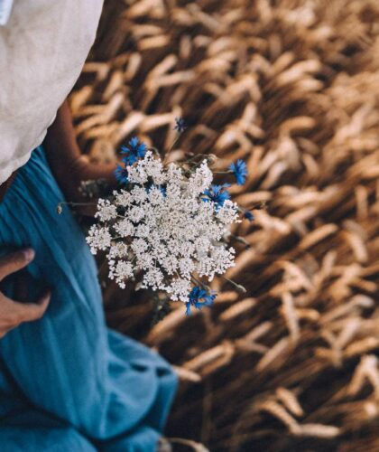 person in wheat field natural materials