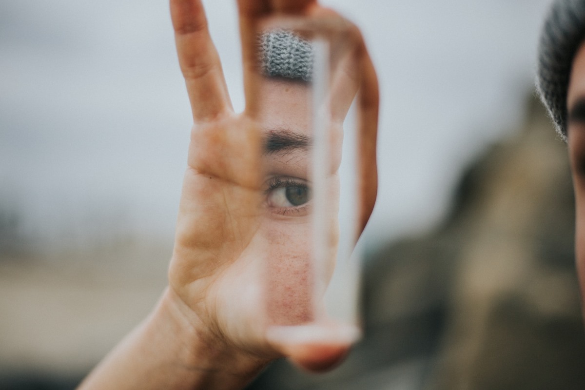 Closeup Person Holding Mirror. Psychodermatology.