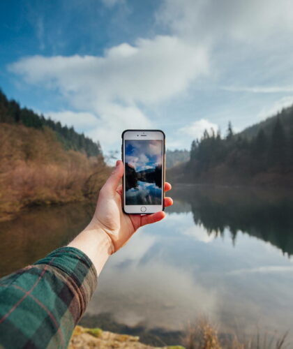 Phone Being Held With Lake Background Sustainable Apps