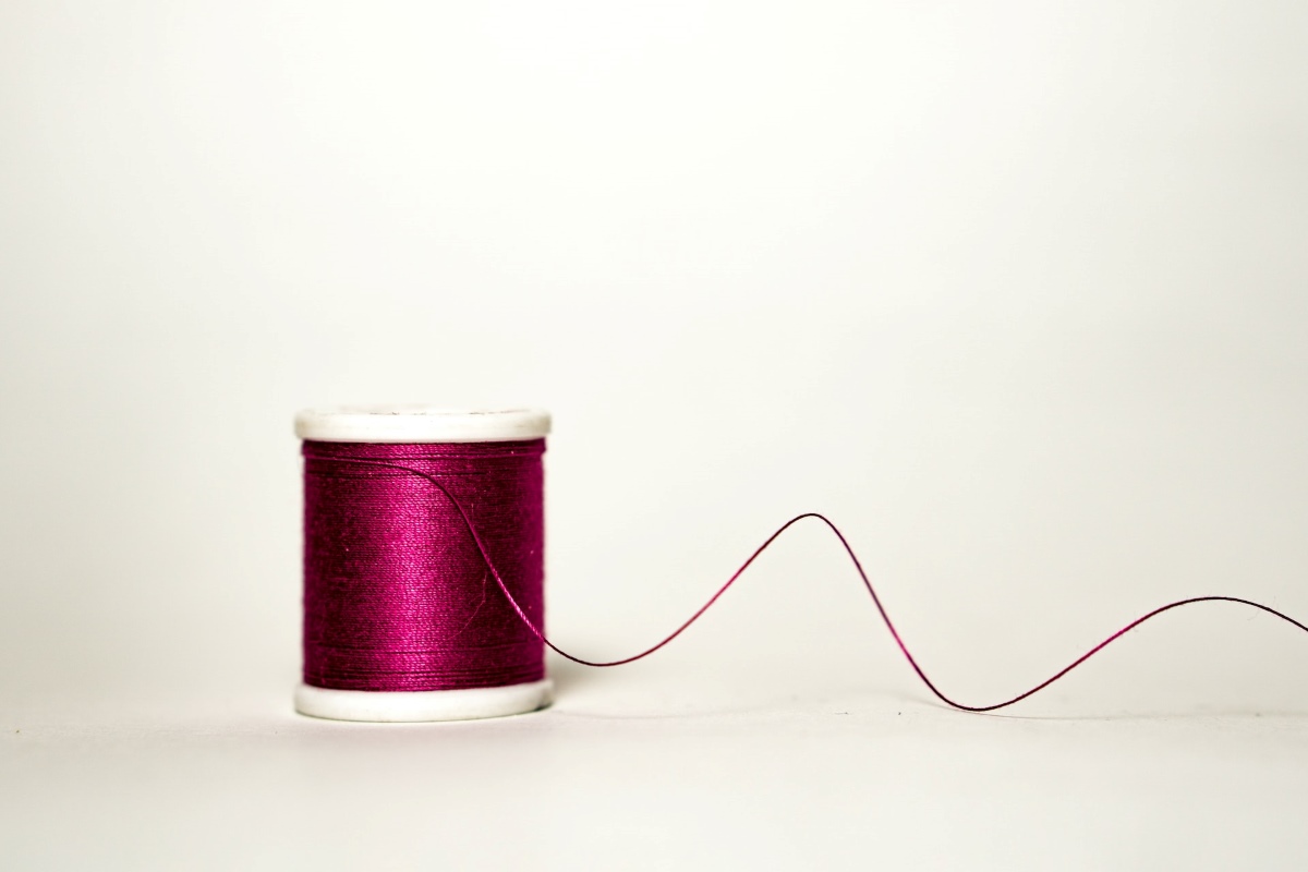 Red Sewing Thread. Bespoke Tailoring. 